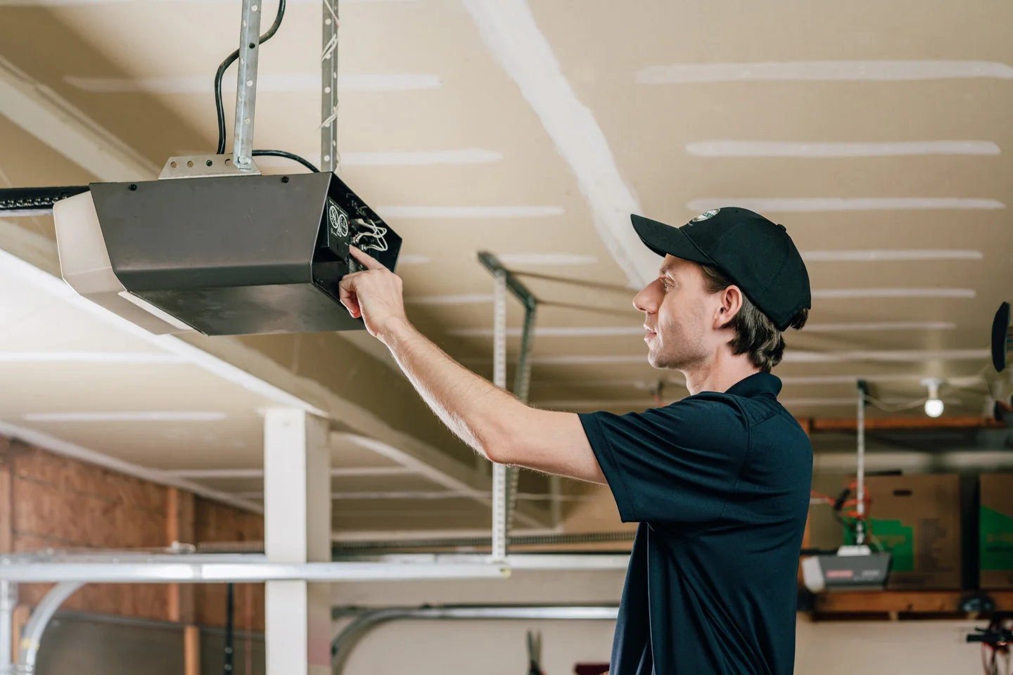 Precision Garage Door technician installing a new garage door opener